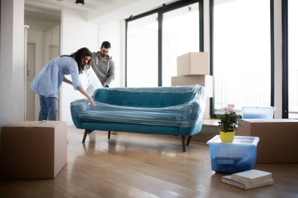 Couple moving sofa | America's Flooring Store