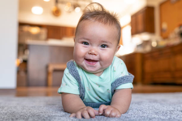Baby laying on carpet | America's Flooring Store